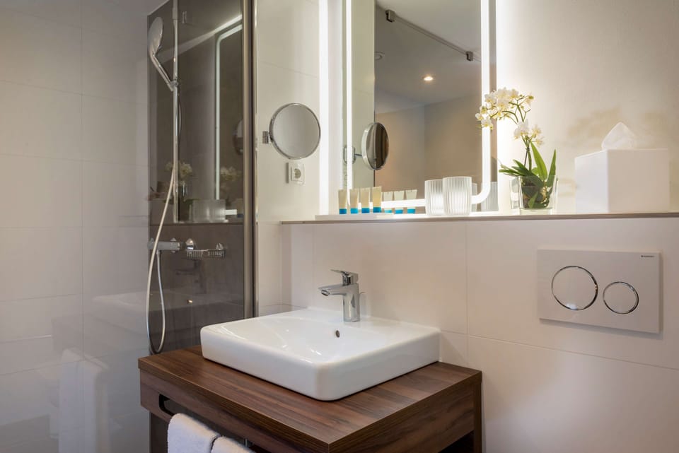 Shower, rainfall showerhead, hair dryer, towels