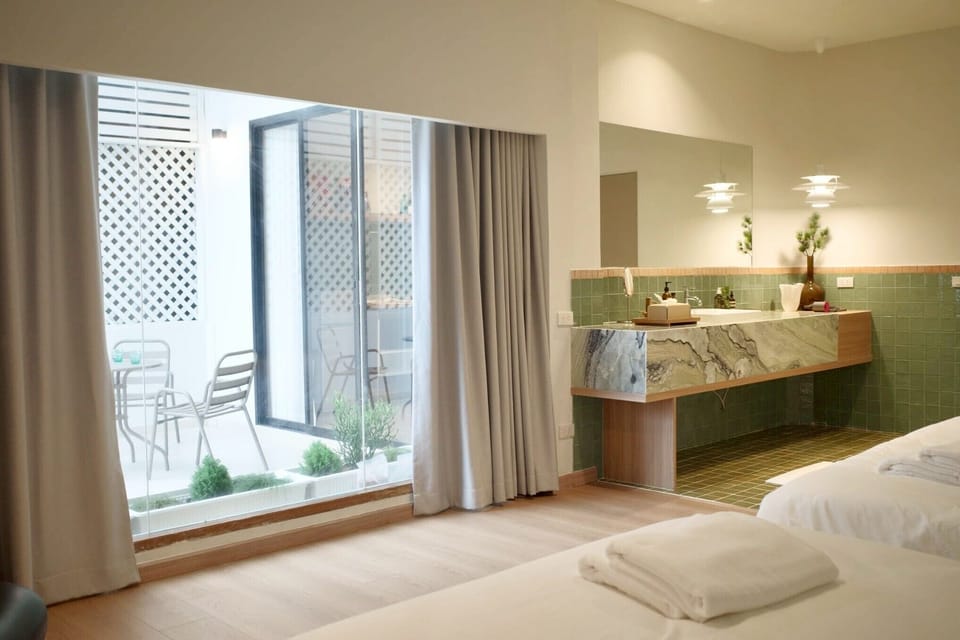 Design Suite, 2 Bedrooms, Terrace | Bathroom | Separate tub and shower, free toiletries, hair dryer, slippers