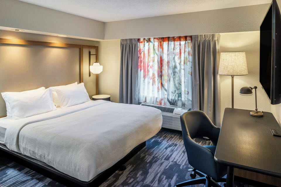 Premium bedding, desk, laptop workspace, blackout drapes