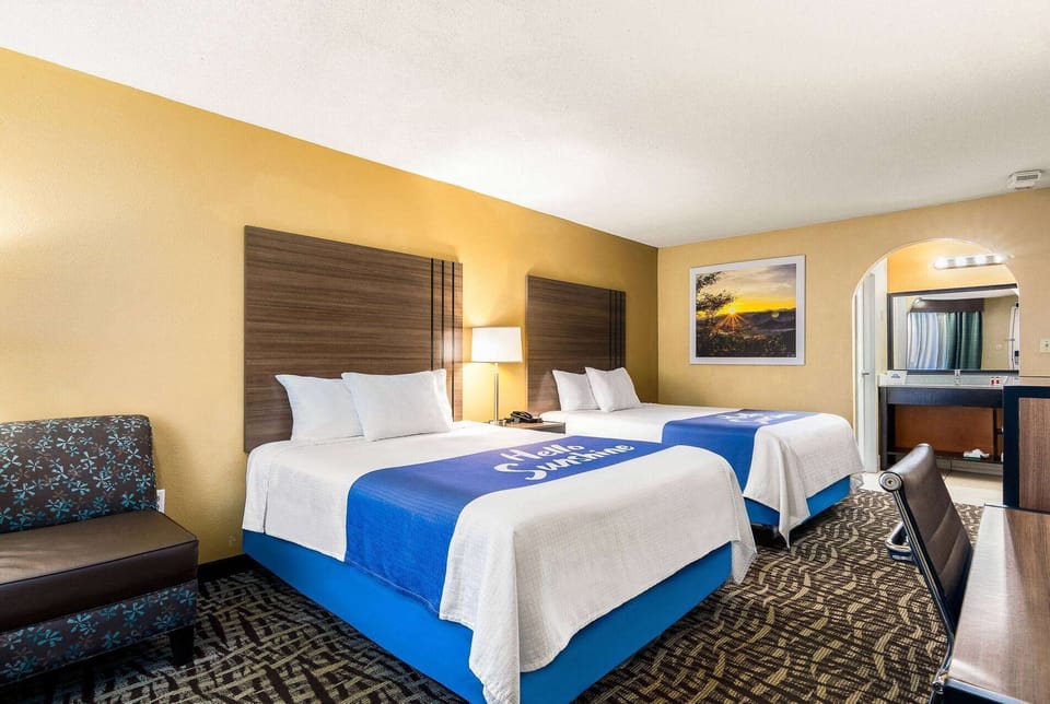 Premium bedding, desk, laptop workspace, iron/ironing board