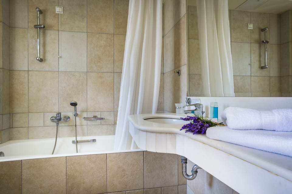 Deluxe Quadruple Room | Bathroom | Combined shower/tub, deep soaking tub, designer toiletries, hair dryer