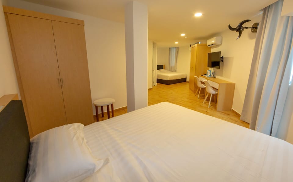 King Suite Room | Desk, blackout drapes, iron/ironing board, free WiFi