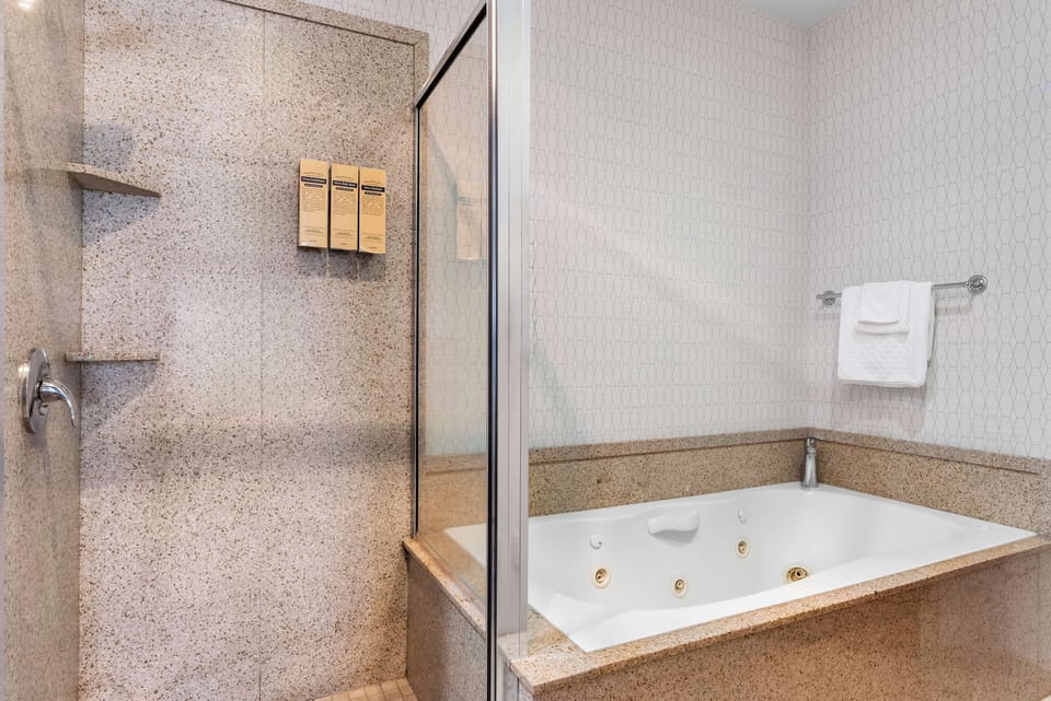 Combined shower/tub, designer toiletries, hair dryer, towels