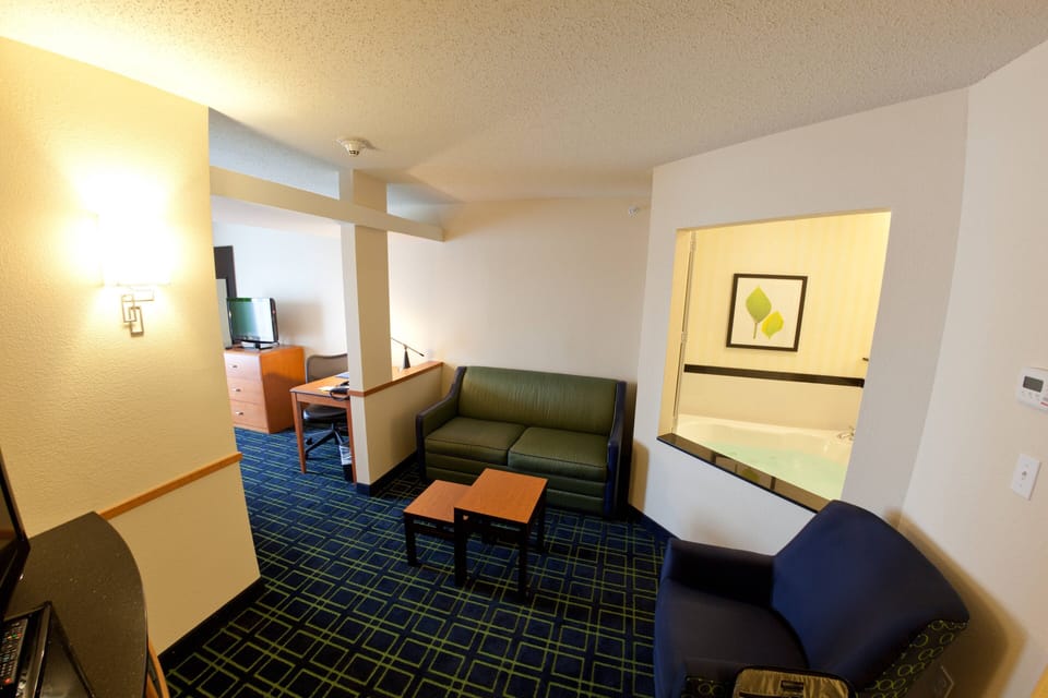 Suite, 1 King Bed with Sofa bed, Bathtub | Living area | 32-inch LCD TV with cable channels, TV