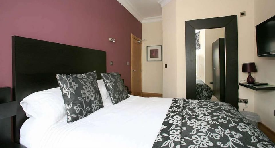Desk, iron/ironing board, bed sheets