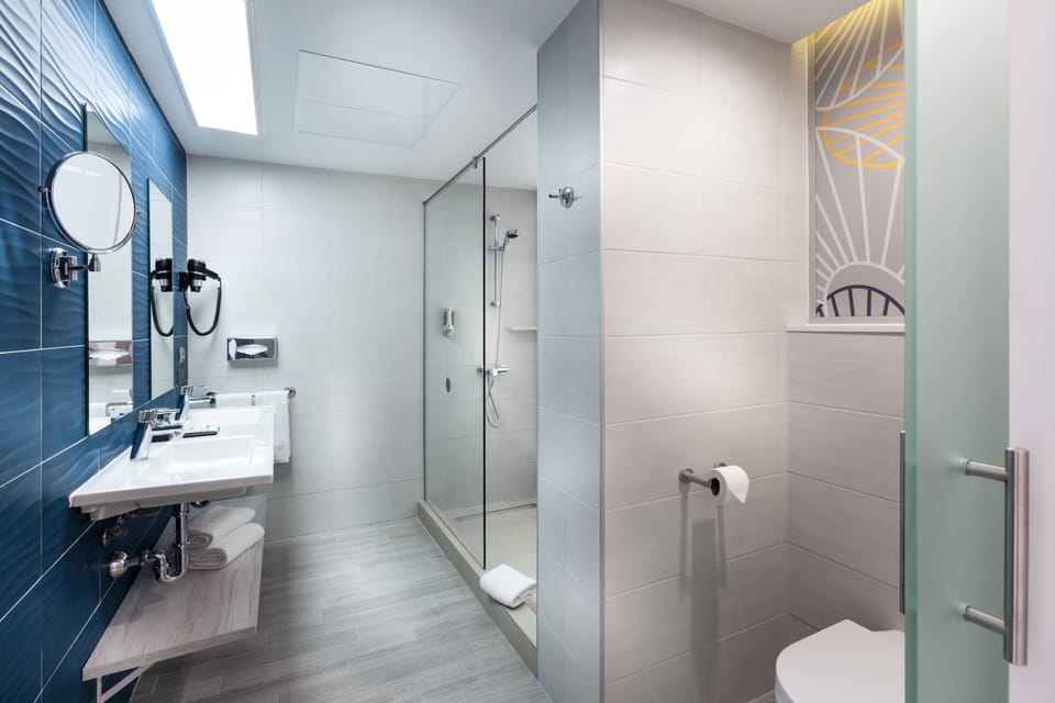 Junior Suite, Sea View (Large Balcony) | Bathroom | Shower, eco-friendly toiletries, hair dryer, towels