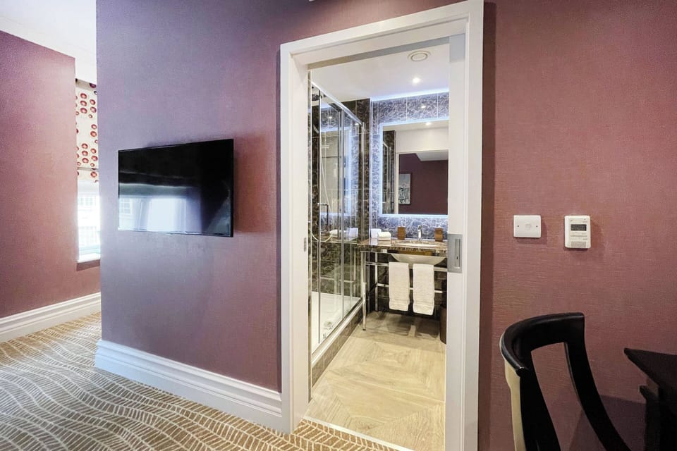 Shower, designer toiletries, hair dryer, bathrobes