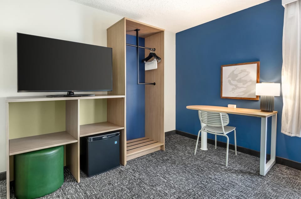 Desk, laptop workspace, blackout drapes, iron/ironing board