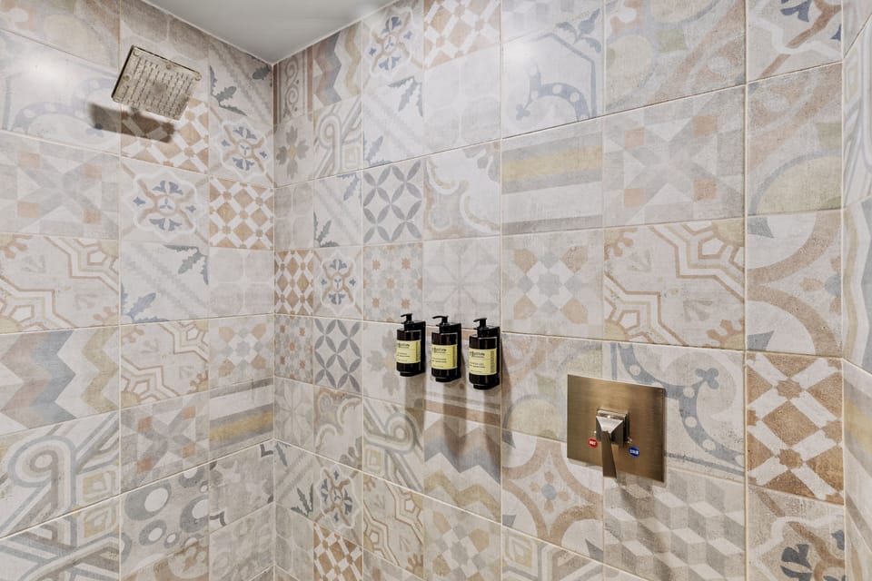 Shower, rainfall showerhead, designer toiletries, hair dryer