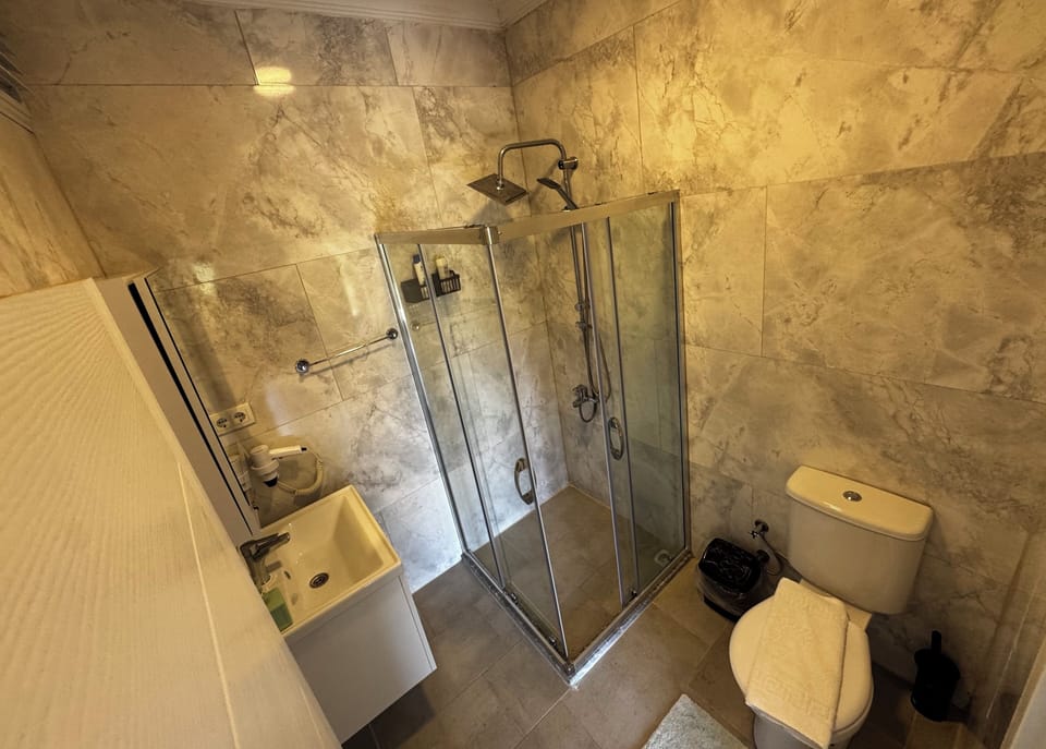 Shower, rainfall showerhead, hair dryer (on request), slippers