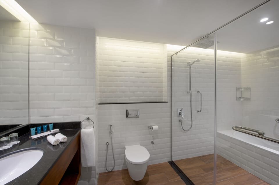 Eco-friendly toiletries, hair dryer, slippers, bidet
