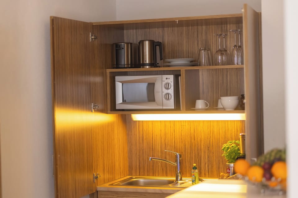 Deluxe Apartment A | Living area | 55-inch flat-screen TV with digital channels, TV