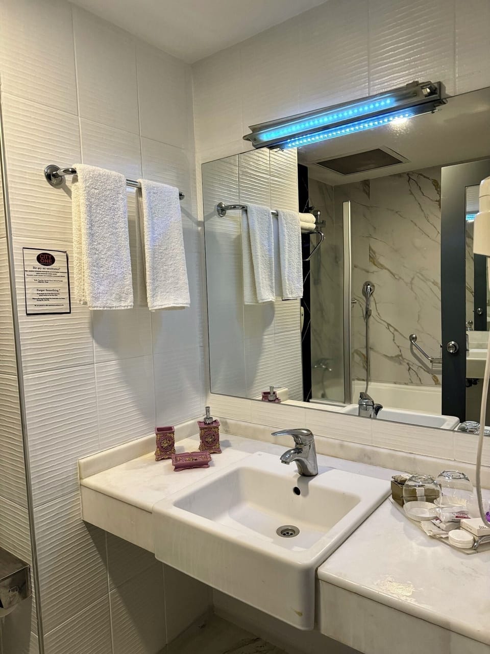 Bathtub, hair dryer, slippers, towels
