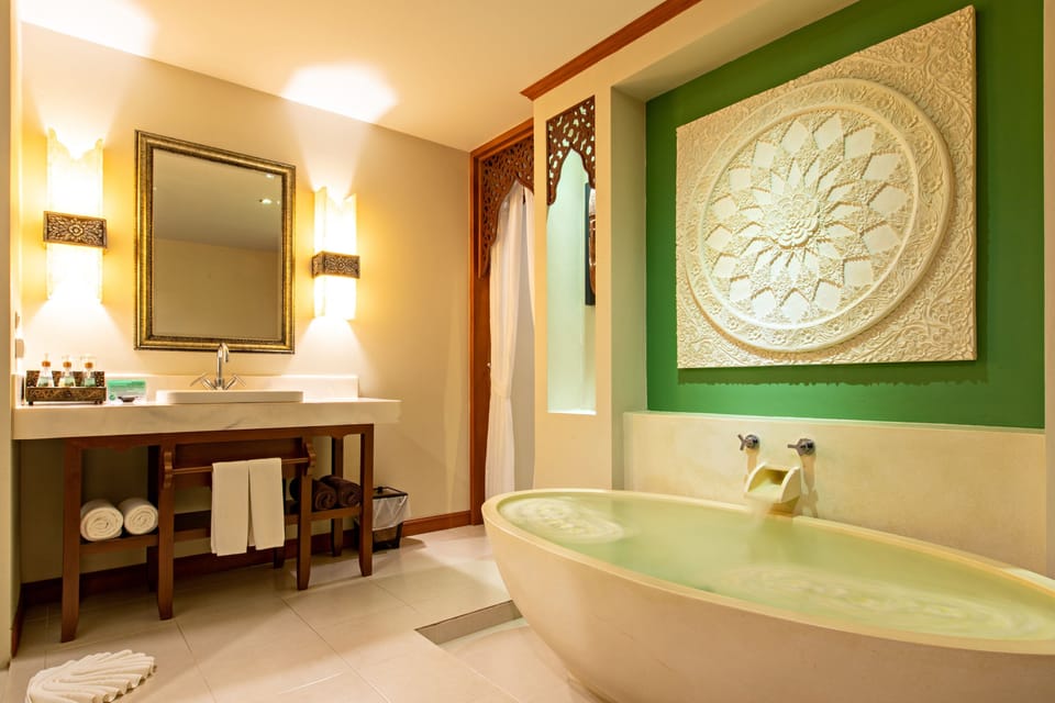 Deluxe Room, Pool View | Bathroom | Hair dryer, slippers, towels, soap