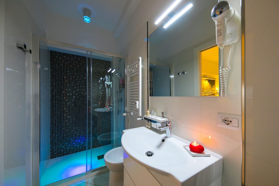 Shower, designer toiletries, hair dryer, slippers
