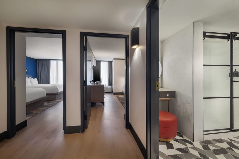 Premium bedding, desk, laptop workspace, blackout drapes