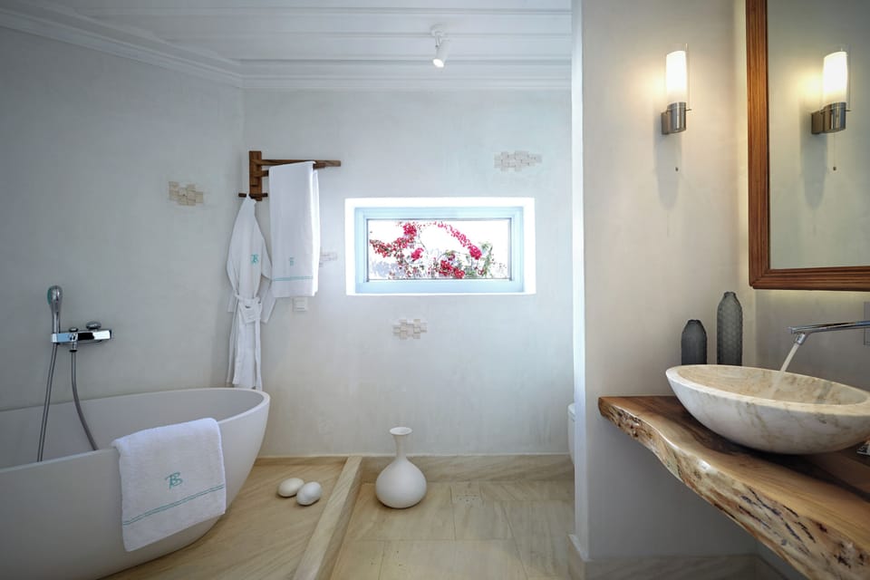 Bathtub, designer toiletries, hair dryer, bathrobes