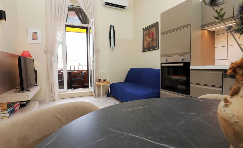 City Apartment, 1 Bedroom, Balcony | Living area | 82-cm flat-screen TV with cable channels, TV