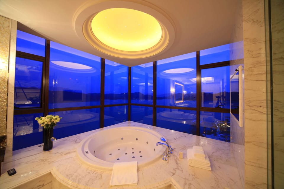 Separate tub and shower, rainfall showerhead, designer toiletries