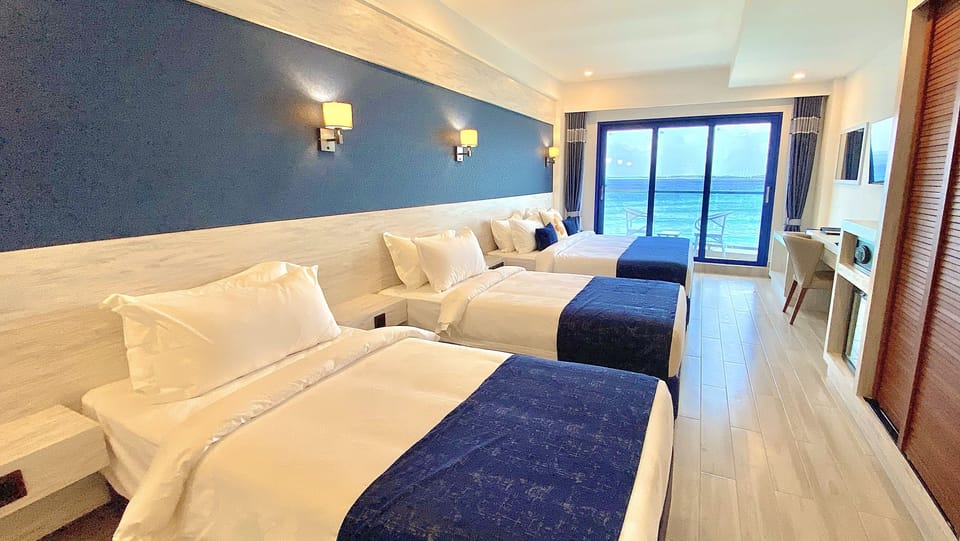 Deluxe Quadruple Room, Balcony, Sea View | Minibar, in-room safe, individually furnished, desk