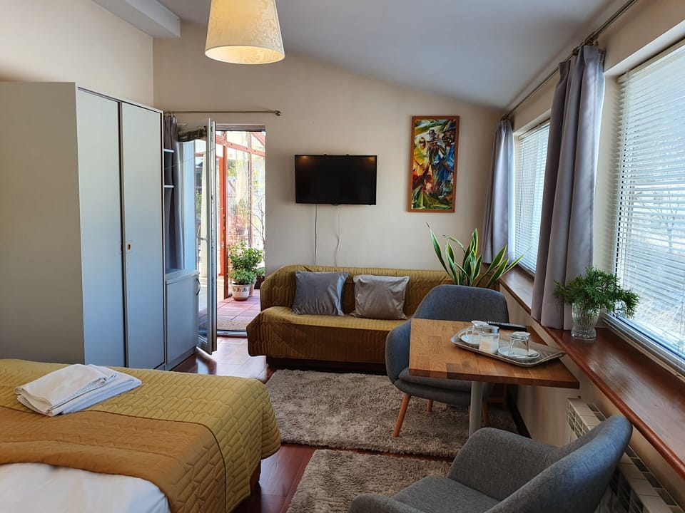 Triple Room, Balcony | Living area | Flat-screen TV