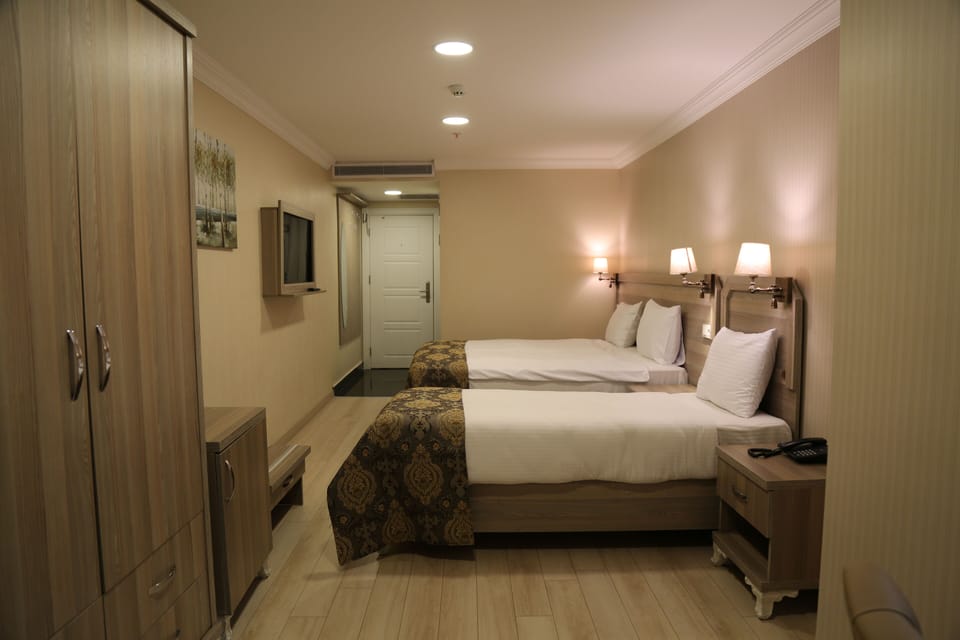 Standard Triple Room | Minibar, in-room safe, soundproofing, iron/ironing board