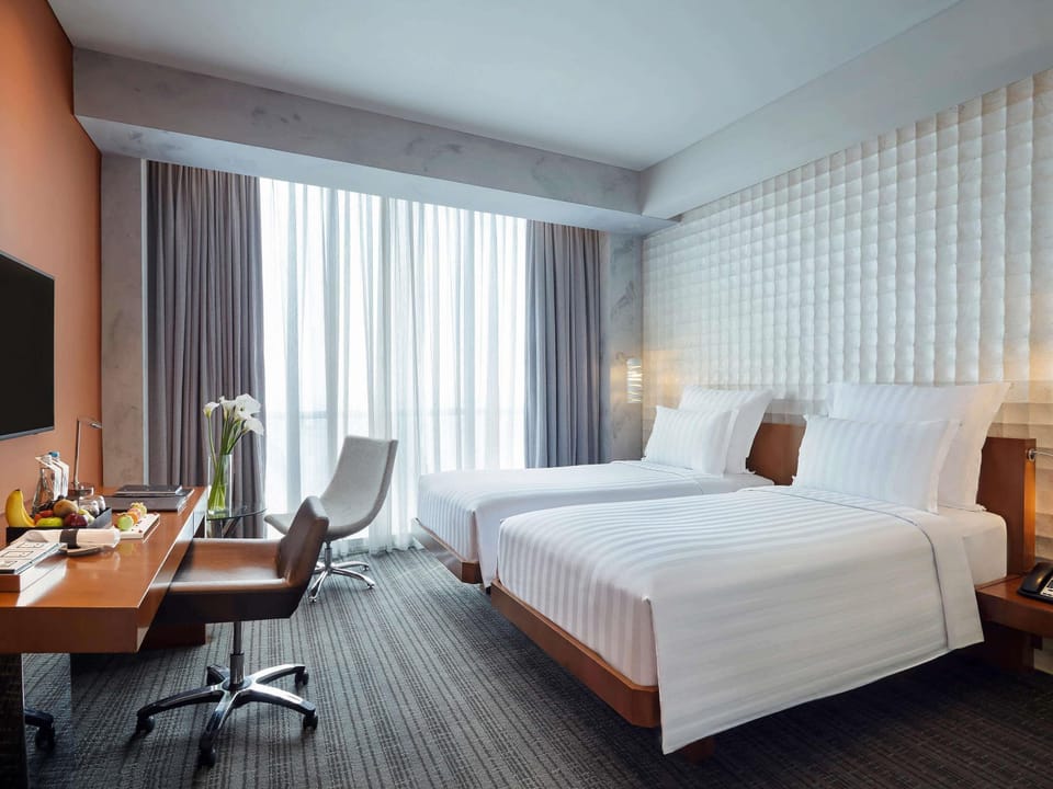 Deluxe Room, 2 Twin Beds | Free minibar items, in-room safe, desk, laptop workspace