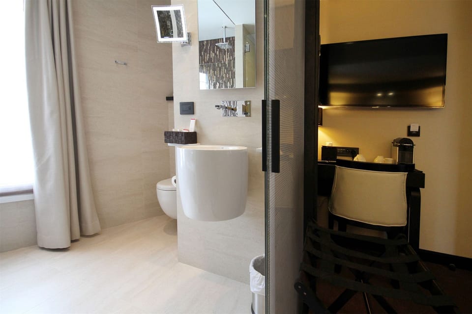 Deep soaking tub, rainfall showerhead, designer toiletries, hair dryer