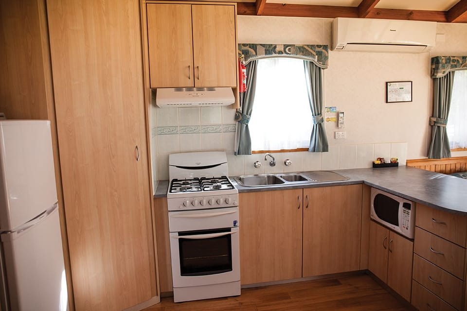 Deluxe Villa, 2 Bedrooms | Private kitchen | Full-size fridge, microwave, stovetop, cookware/dishes/utensils