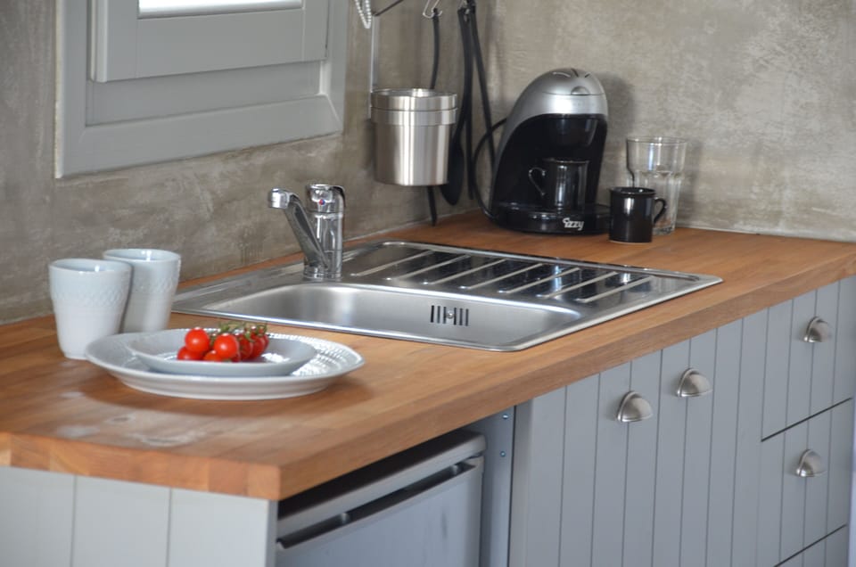 Mini-fridge, stovetop, electric kettle, cookware/dishes/utensils