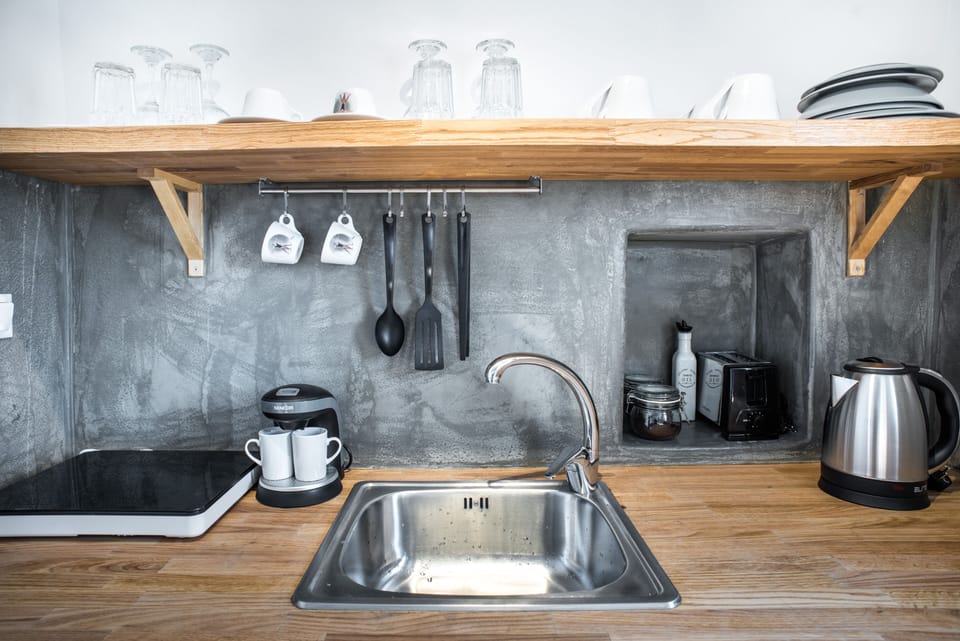 Mini-fridge, stovetop, electric kettle, cookware/dishes/utensils