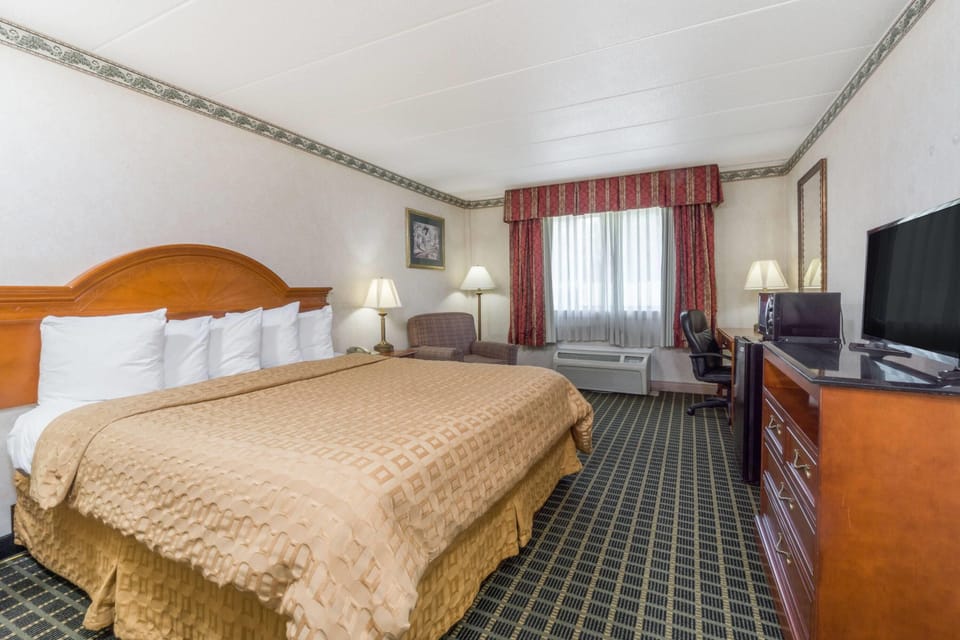 Desk, laptop workspace, blackout drapes, iron/ironing board