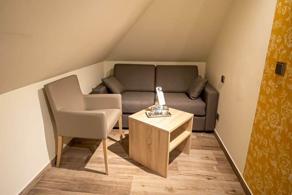 Family Quadruple Room | Living area | 40-inch LED TV with satellite channels, TV
