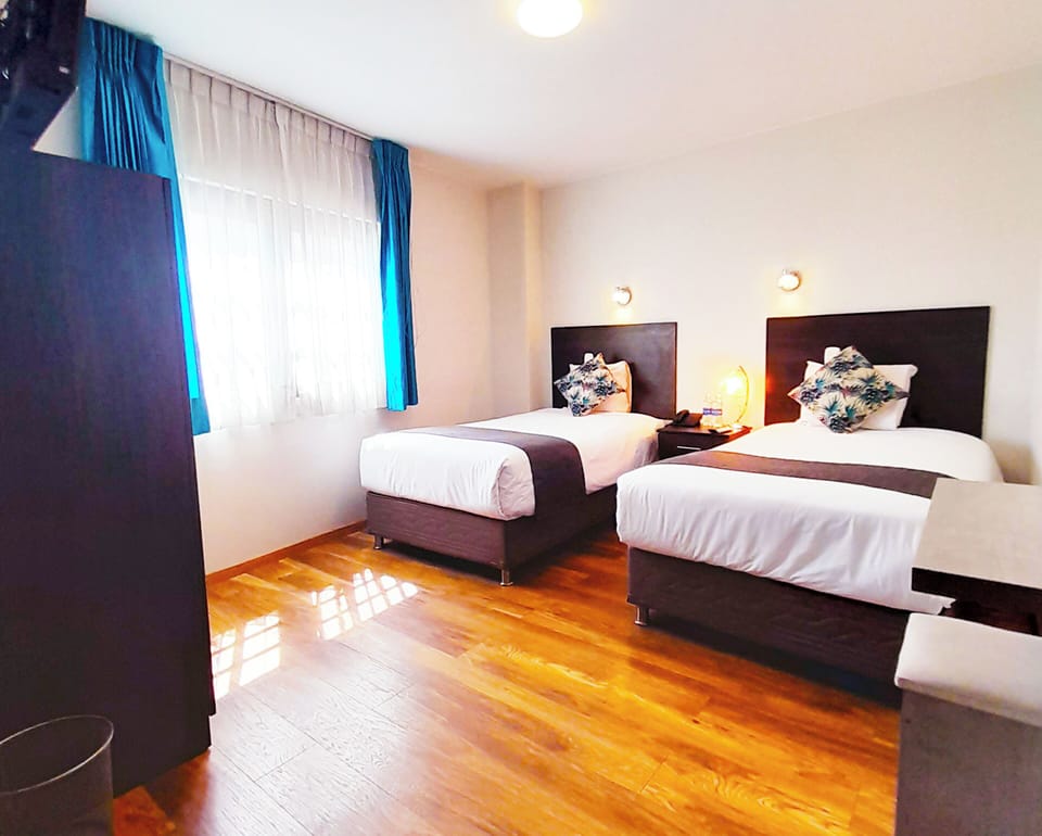 Standard Twin Room | Down comforters, laptop workspace, blackout drapes, iron/ironing board