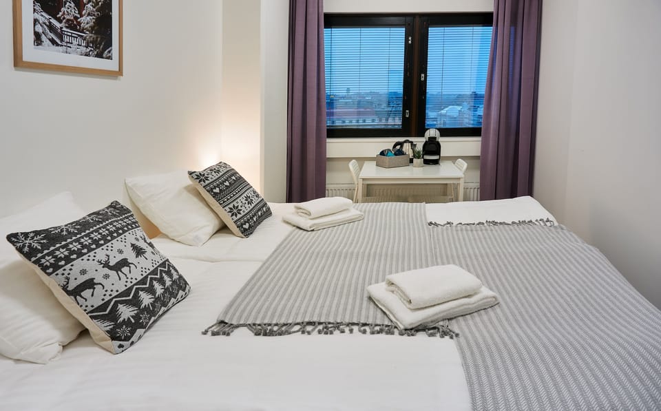 Hypo-allergenic bedding, desk, laptop workspace, blackout drapes