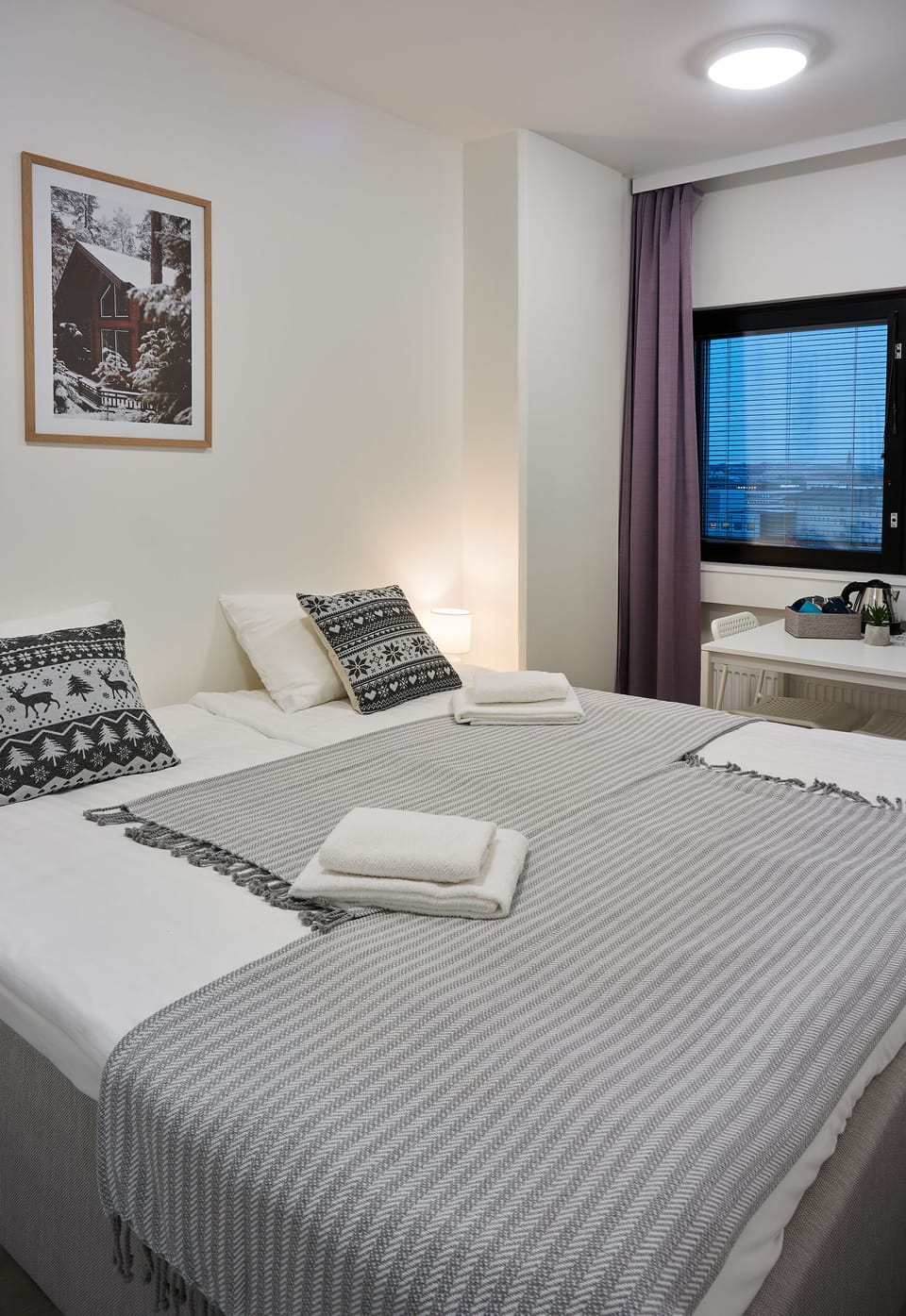 Hypo-allergenic bedding, desk, laptop workspace, blackout drapes