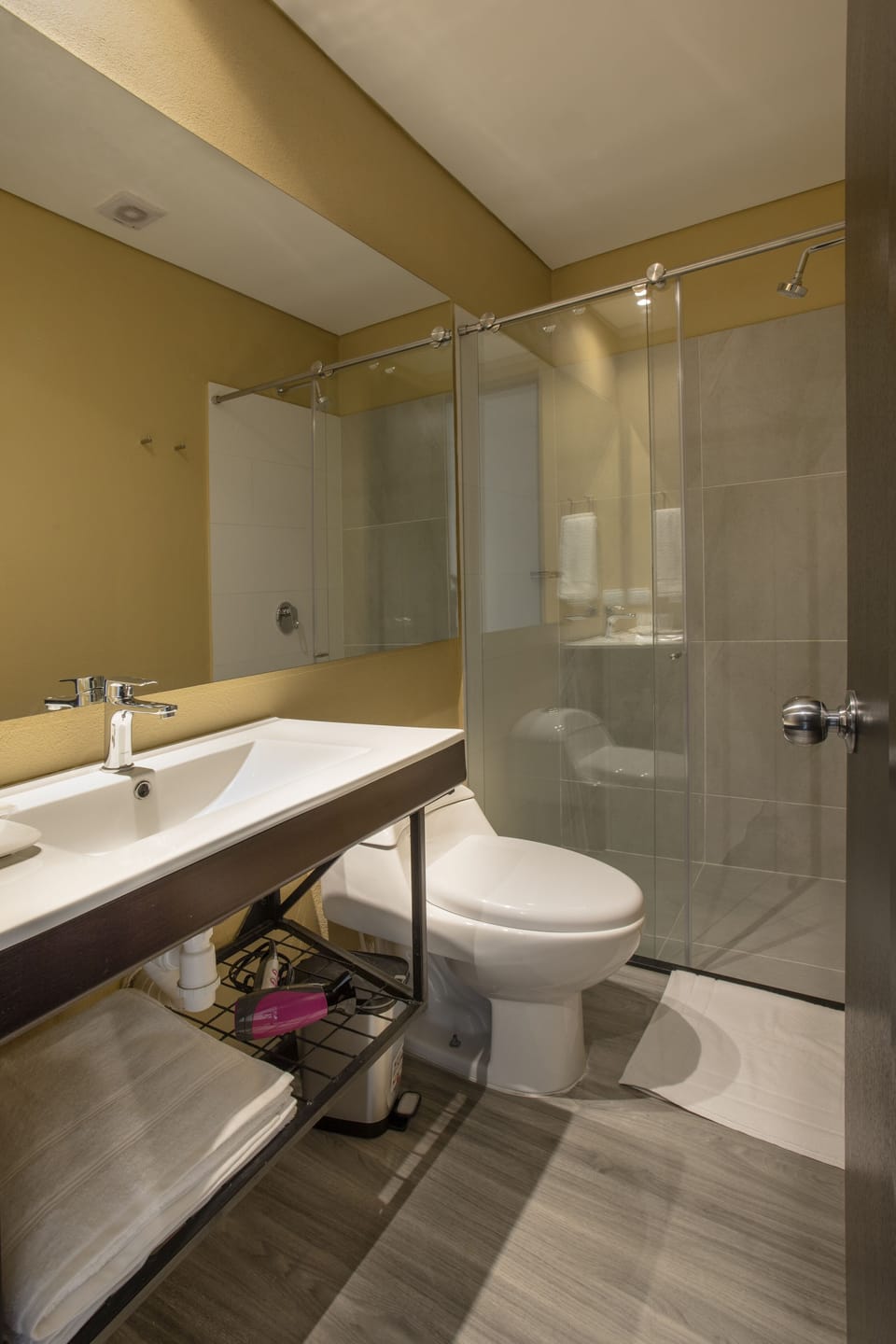 Shower, rainfall showerhead, hair dryer, towels