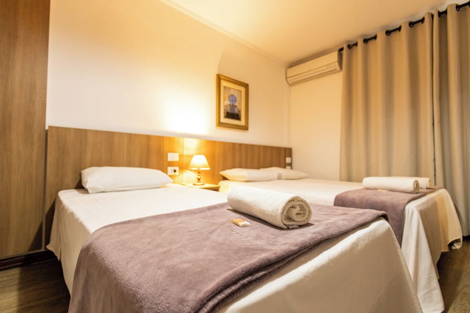 Standard Triple Room | Minibar, in-room safe, desk, blackout drapes