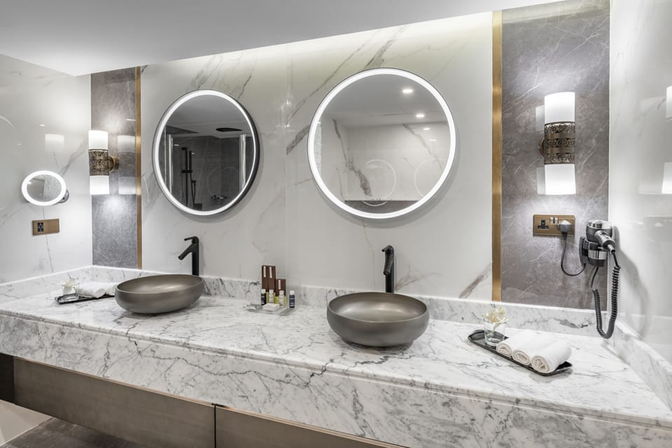 Deep soaking tub, rainfall showerhead, designer toiletries, hair dryer