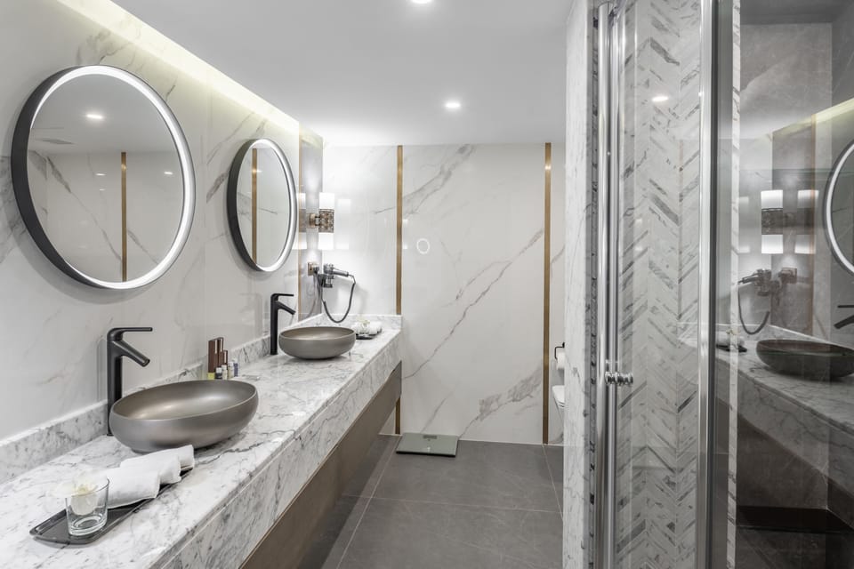 Deep soaking tub, rainfall showerhead, designer toiletries, hair dryer