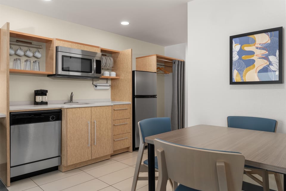 Suite, 1 Queen Bed | Private kitchen | Full-size fridge, microwave, stovetop, dishwasher