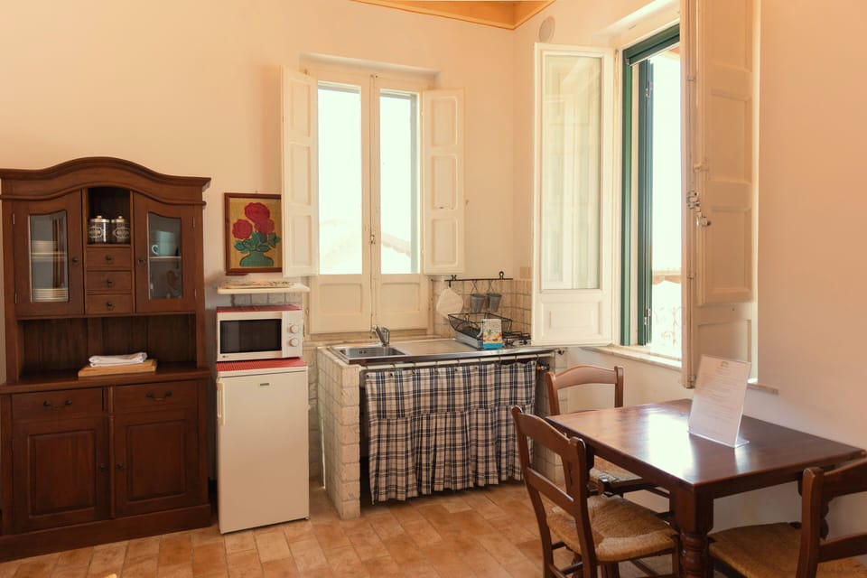 Ortensia Apartment with terrace, mountain view | Private kitchen | Microwave, electric kettle, highchair, cleaning supplies