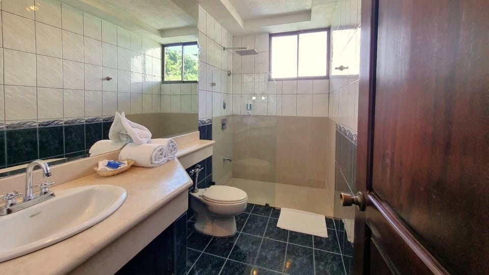 Premium Room, 2 Queen Beds, Non Smoking | Bathroom | Shower, hair dryer, towels