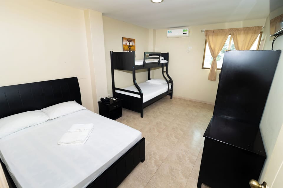 Triple Room | Blackout drapes, iron/ironing board (on request), bed sheets