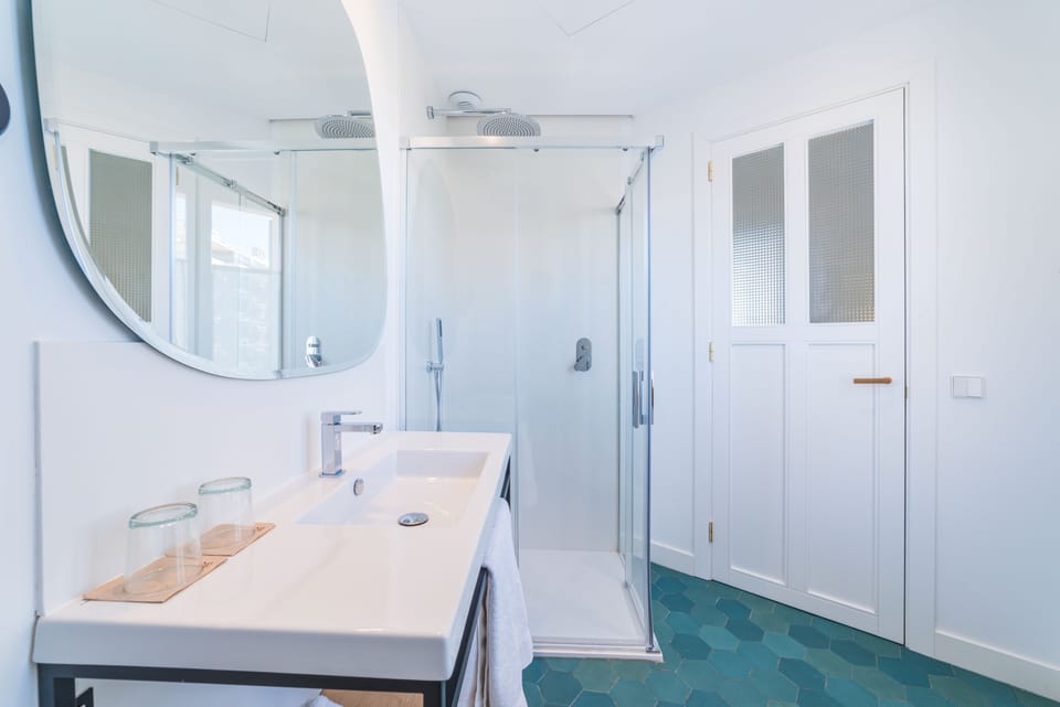 Shower, rainfall showerhead, hair dryer, towels