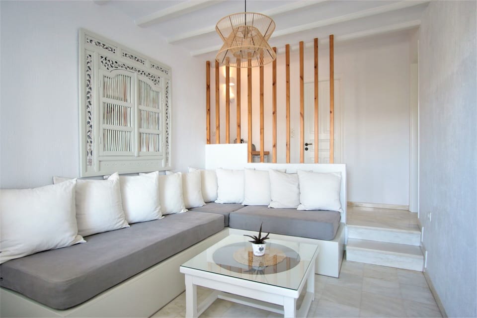 Suite, Partial Sea View | Living area | Flat-screen TV