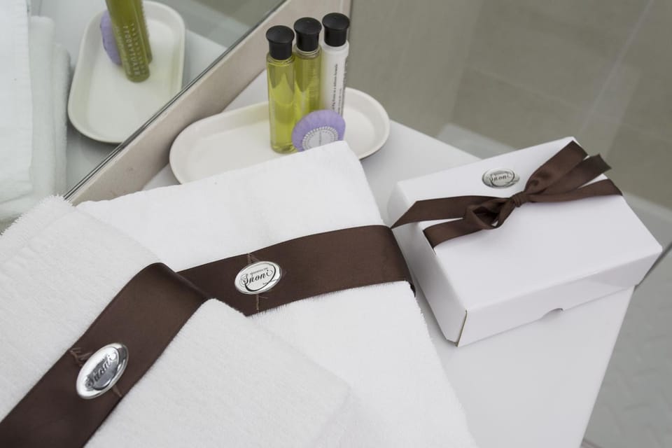 Designer toiletries, hair dryer, slippers, bidet