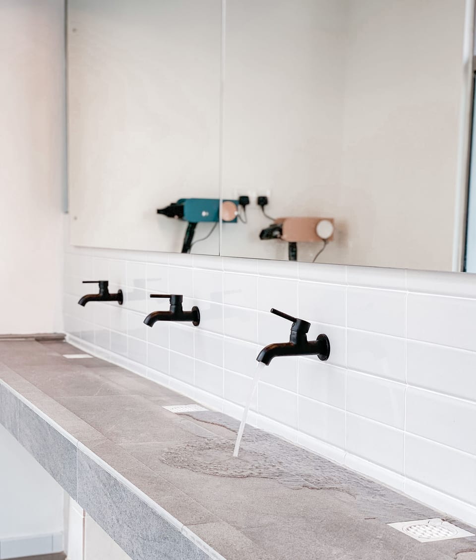 Shower, hair dryer, slippers, towels