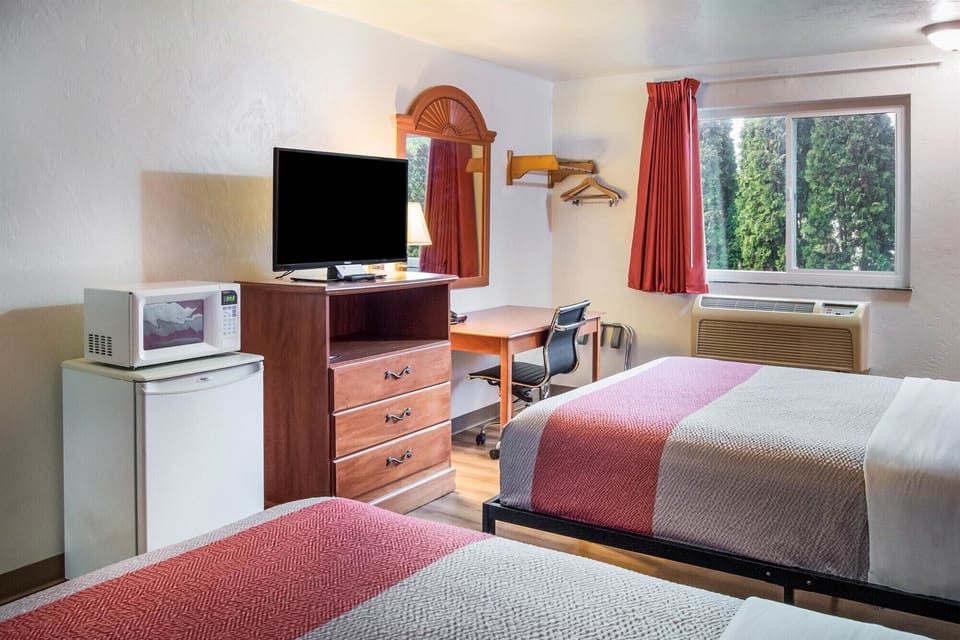 Desk, laptop workspace, bed sheets