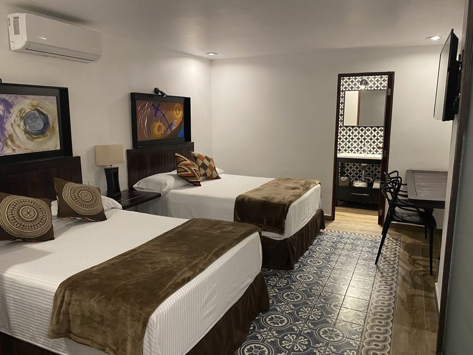 Deluxe Room, 2 Double Beds | Iron/ironing board, WiFi (free), bed sheets